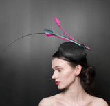 Black button beret with black quill, and striking pink arrow feathers