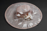 blush pink, wide brimmed hat, with silk flowers and spray of feathers