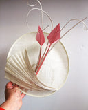 Cream saucer hat, with pink feathers, and cream twisted quills