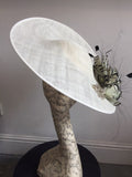 Large white saucer hat with spray of black and white feathers and dimonte motif