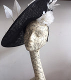 Large black and white saucer hat, with big white silk rose and 3 white arrow feathers