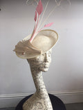 Cream saucer hat, with pink feathers, and cream twisted quills