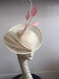 Cream saucer hat, with pink feathers, and cream twisted quills