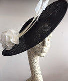 Large black and white saucer hat, with big white silk rose and 3 white arrow feathers