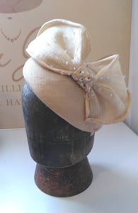 Cream hat/fascinator with bow, dotted with crystals