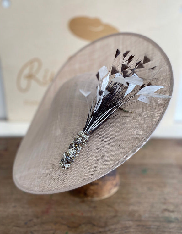 Large coffee coloured saucer hat, spray of small feathers incased in beads