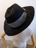black triby hat with light blue band.