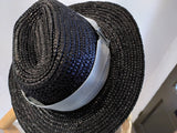 black triby hat with light blue band.