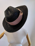 black triby hat with soft pink band.