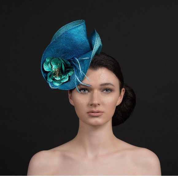 Turquoise blue fascinator, with blue leather rose and spray of feathers, perfect for ascot and weddings