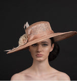 blush pink, wide brimmed hat, with silk flowers and spray of feathers