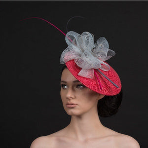 Pink fascinator with oversized grey bow with pink and grey quills