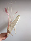 Cream saucer hat, with pink feathers, and cream twisted quills