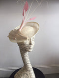 Cream saucer hat, with pink feathers, and cream twisted quills