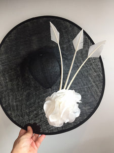 Large black and white saucer hat, with big white silk rose and 3 white arrow feathers