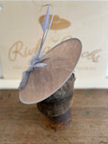 Grey saucer hat with grey feathers, quills and grey arrow feathers