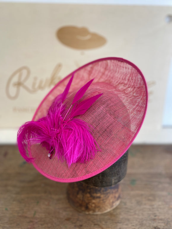 Shocking pink saucer hat with a big spray of pink feathers