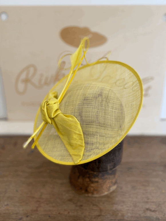 Sunny yellow saucer hat with silk bow and feathers