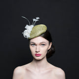 light green button beret hat/fascinator with a silk white rose and a spray of white feathers